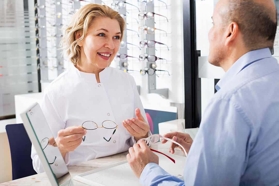 An optometrist having a discussion with a patient