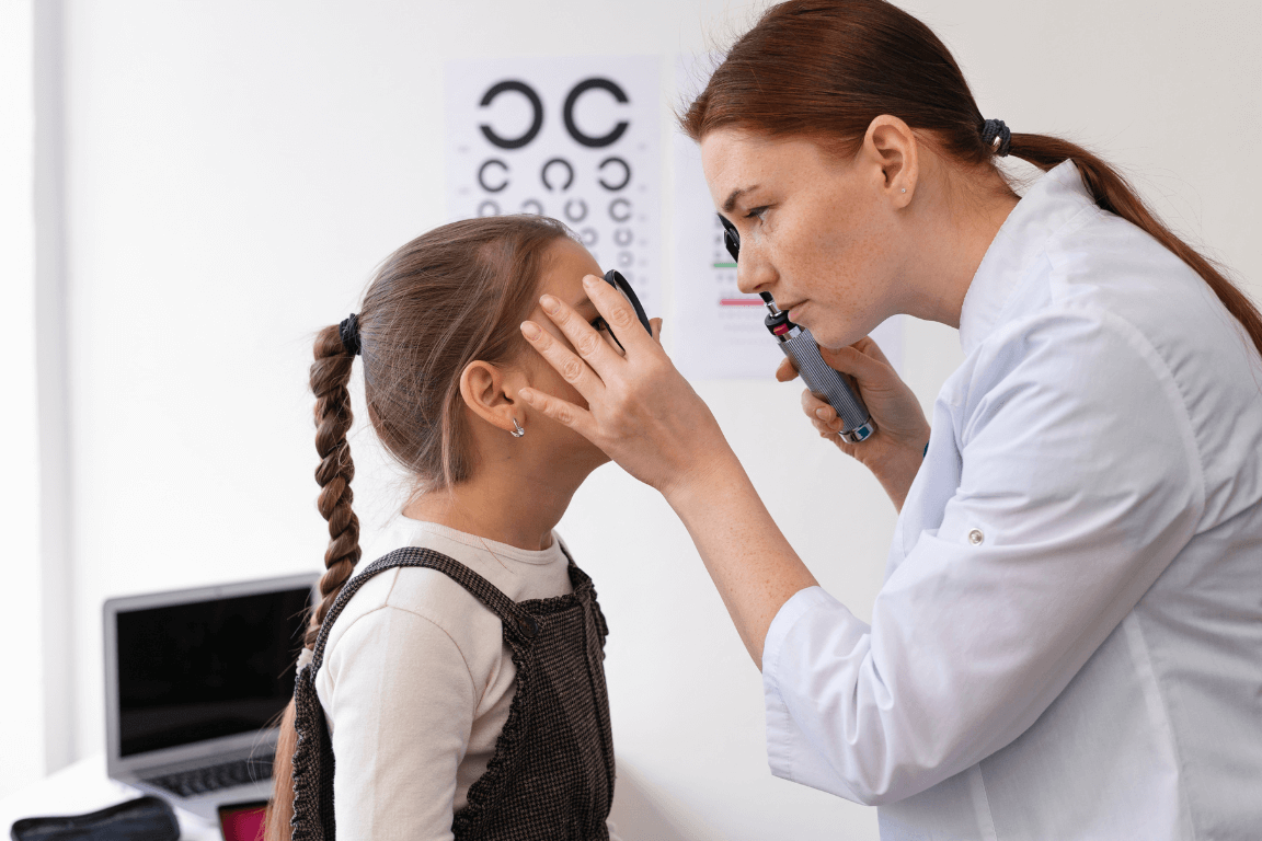 An optometrist conducting an eye examination for a young patient