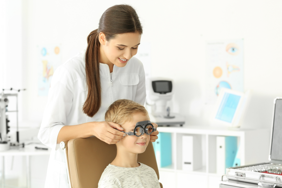 An eye care professional assisting a myopic pediatric patient.