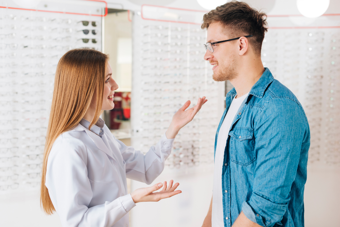 An optometrist chatting with a patient