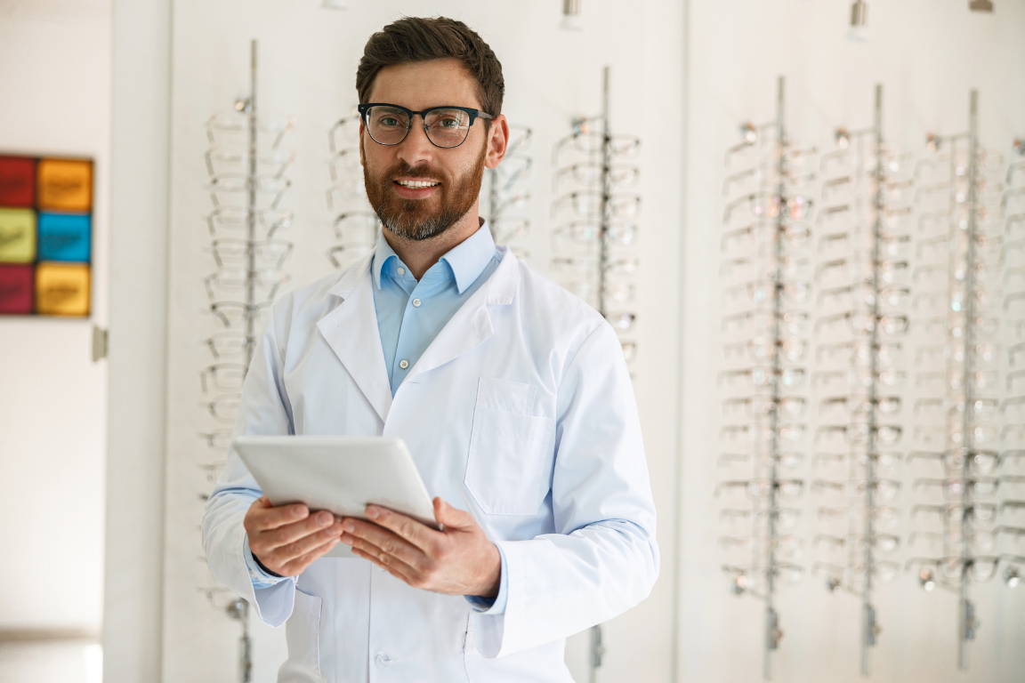 An optometrist checking data and analytics from his tablet
